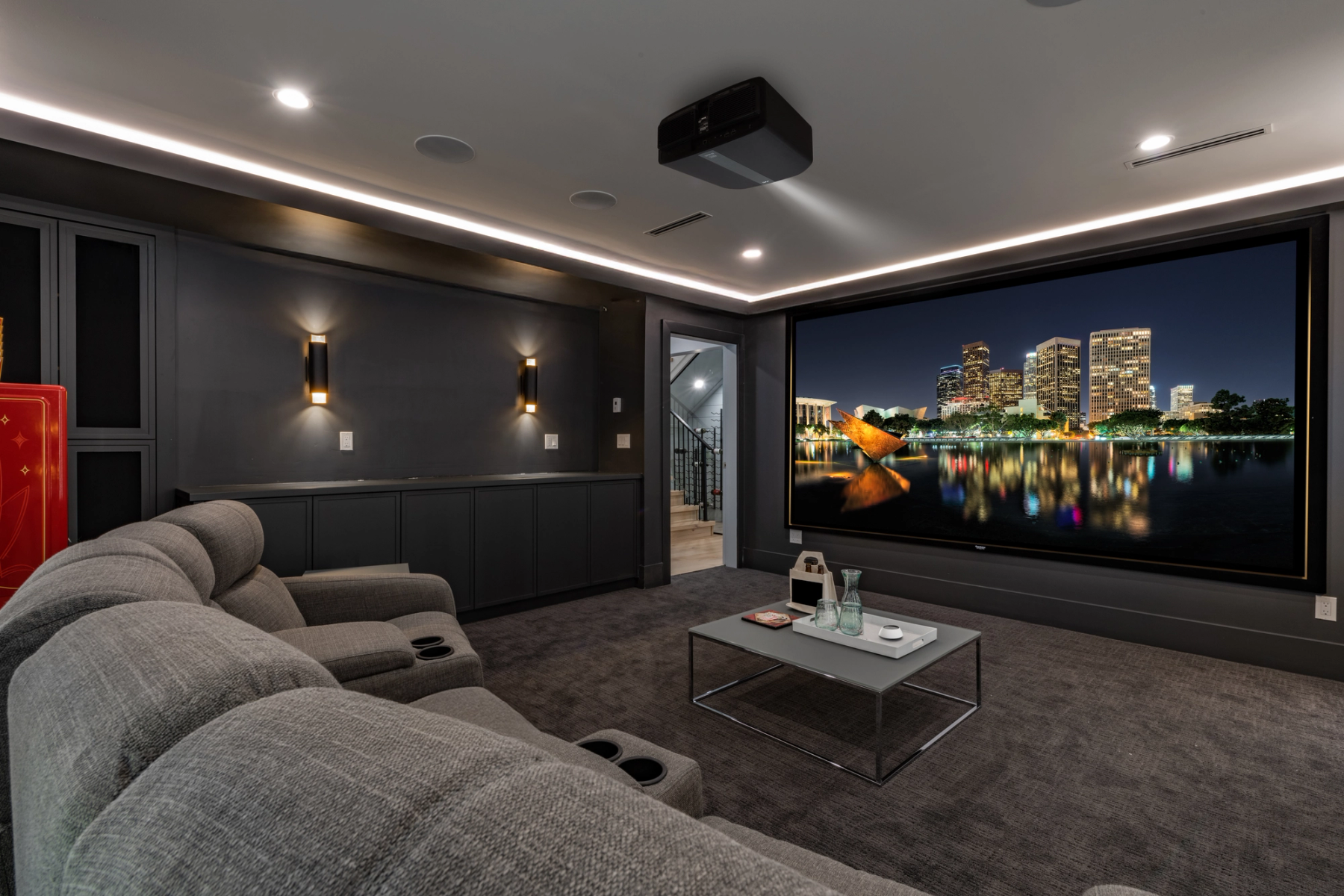 Dedicated private cinema with projection, architectural speakers, and theater seating