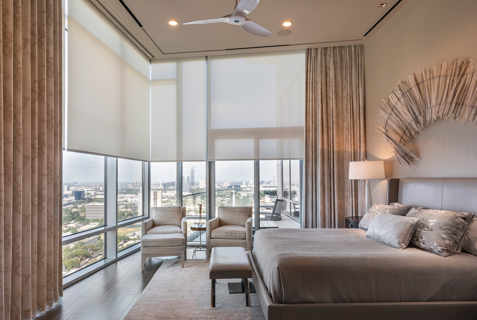 Bright interior with full-height automated roller shades and drapery
